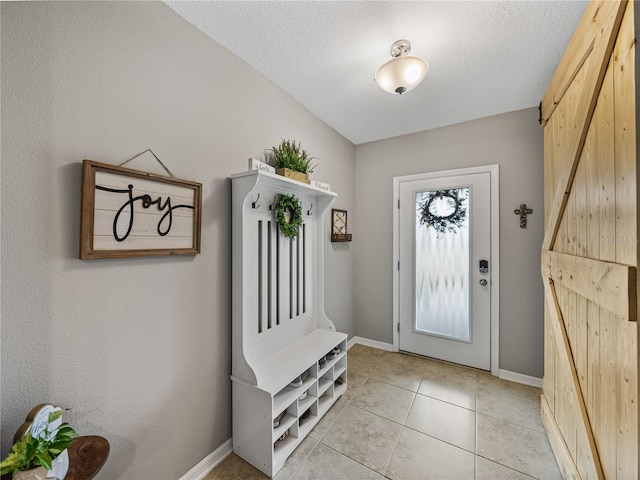 tiled foyer entrance featuring a textured ceiling