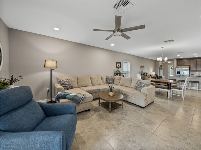 living room featuring ceiling fan with notable chandelier