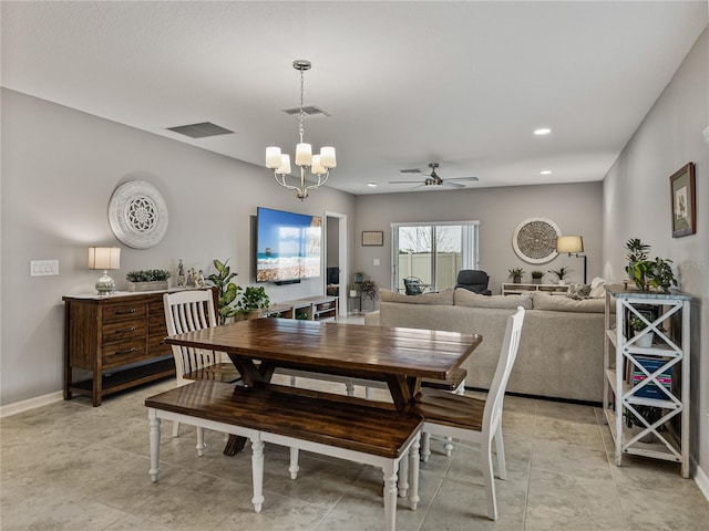 dining area featuring ceiling fan with notable chandelier