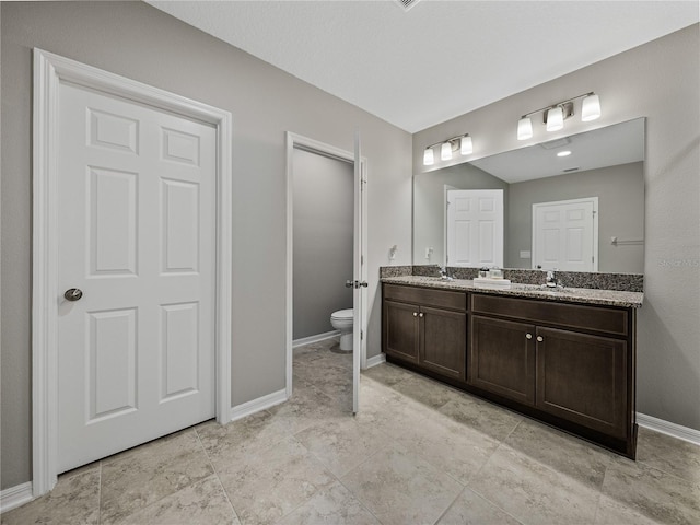 bathroom featuring toilet and vanity