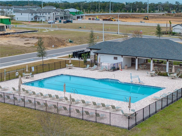 view of swimming pool with a lawn and a patio area