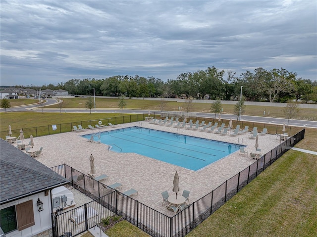 view of pool featuring a lawn and a patio area