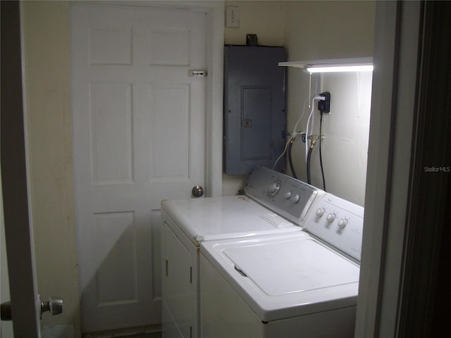 laundry room with washing machine and dryer and electric panel