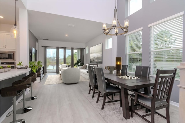 dining room featuring light hardwood / wood-style flooring and a notable chandelier