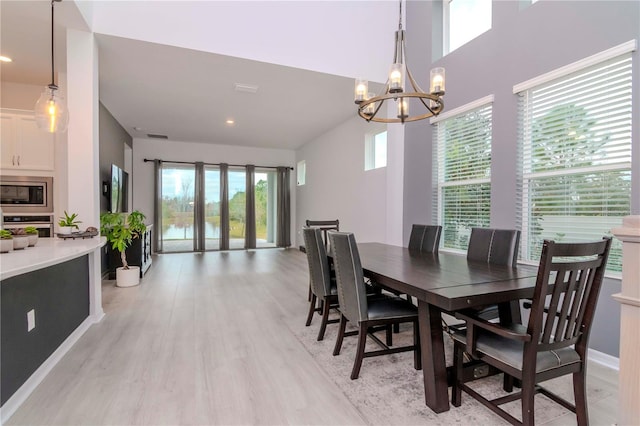 dining room featuring an inviting chandelier and light hardwood / wood-style floors