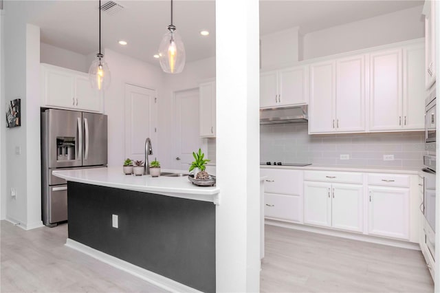 kitchen with stainless steel fridge with ice dispenser, hanging light fixtures, white cabinets, sink, and backsplash