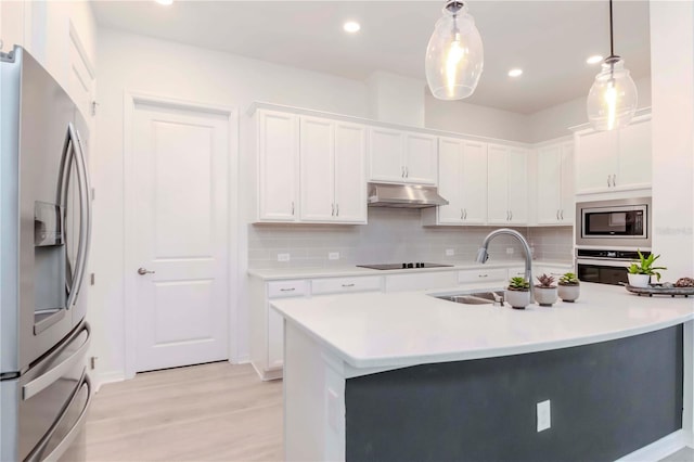 kitchen with white cabinets, hanging light fixtures, and appliances with stainless steel finishes