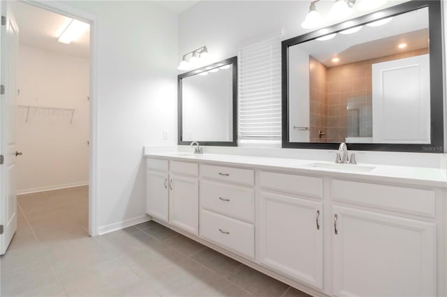 bathroom with tile patterned floors, vanity, and walk in shower