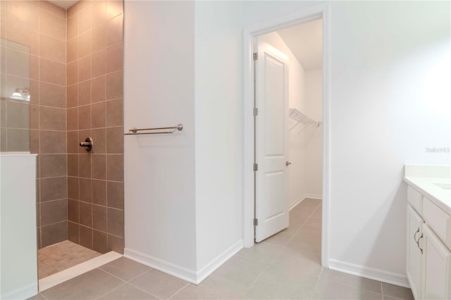 bathroom featuring tiled shower, tile patterned floors, and vanity