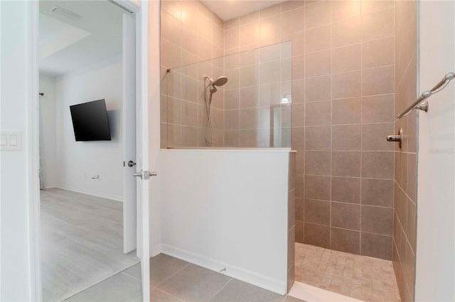 bathroom featuring a tile shower and tile patterned flooring