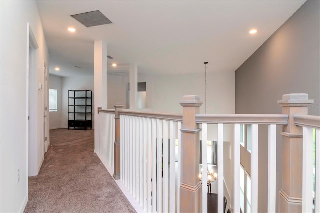 hall with light colored carpet