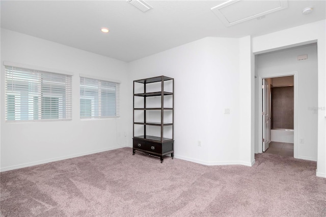 spare room featuring light colored carpet