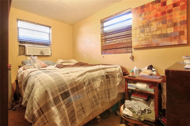 carpeted bedroom with cooling unit, a textured ceiling, and multiple windows