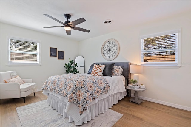 bedroom with ceiling fan and light hardwood / wood-style floors