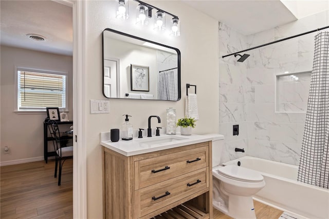 full bathroom with wood-type flooring, toilet, shower / tub combo, and vanity