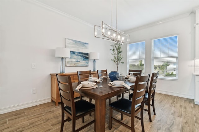 dining room with crown molding and light wood-type flooring