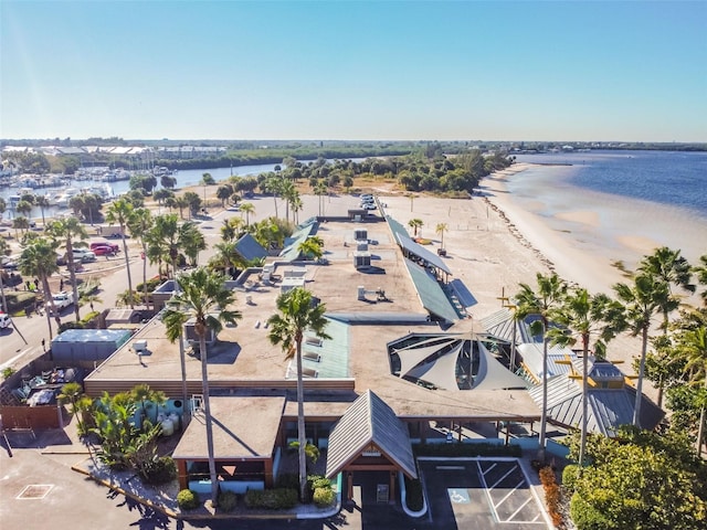 drone / aerial view featuring a water view and a beach view