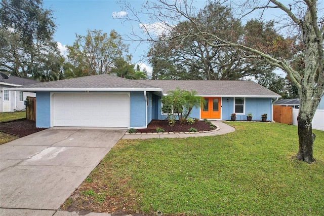 single story home with a garage and a front lawn