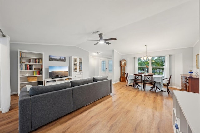 living room with built in shelves, light hardwood / wood-style floors, lofted ceiling, and ornamental molding