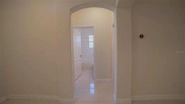 hall featuring light tile patterned floors