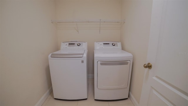 laundry area with light tile patterned floors and independent washer and dryer