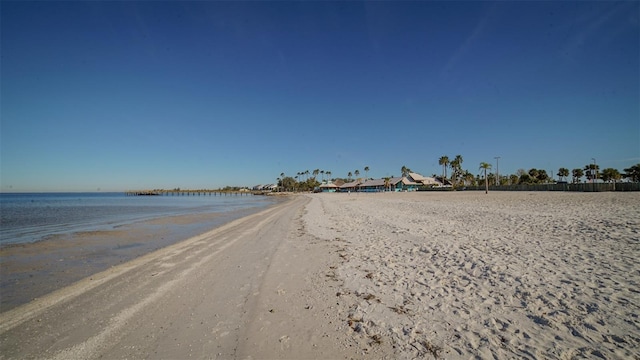 view of street featuring a water view and a beach view