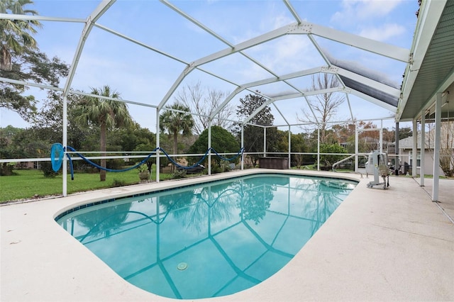 view of swimming pool featuring glass enclosure and a patio