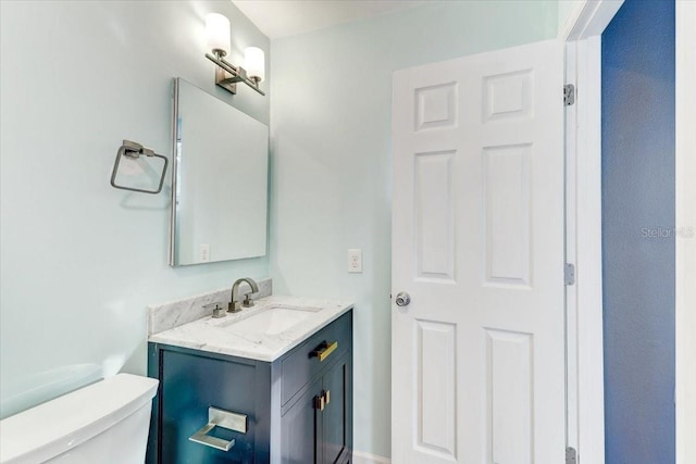 bathroom with toilet and vanity