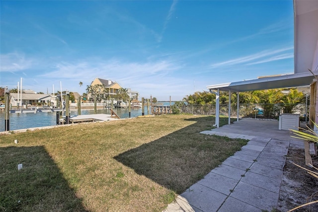 view of yard with a water view and a dock