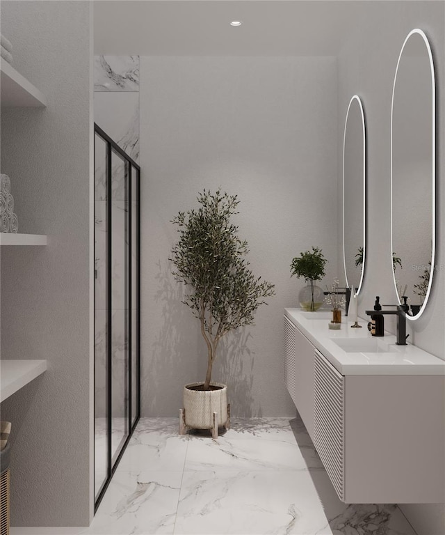 full bathroom featuring double vanity, marble finish floor, a shower stall, and a sink