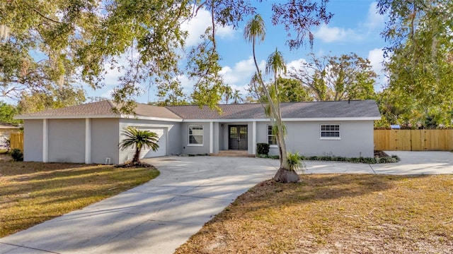 single story home with a garage and a front lawn