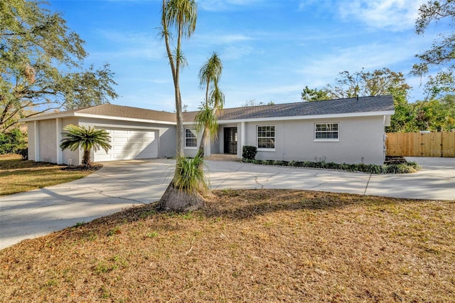 single story home with a garage and a front yard