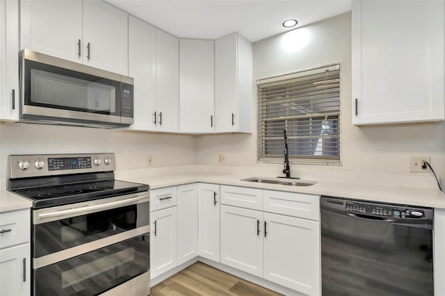 kitchen featuring white cabinetry, stainless steel appliances, and sink