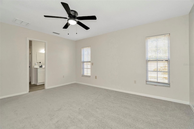 unfurnished room with ceiling fan and light colored carpet