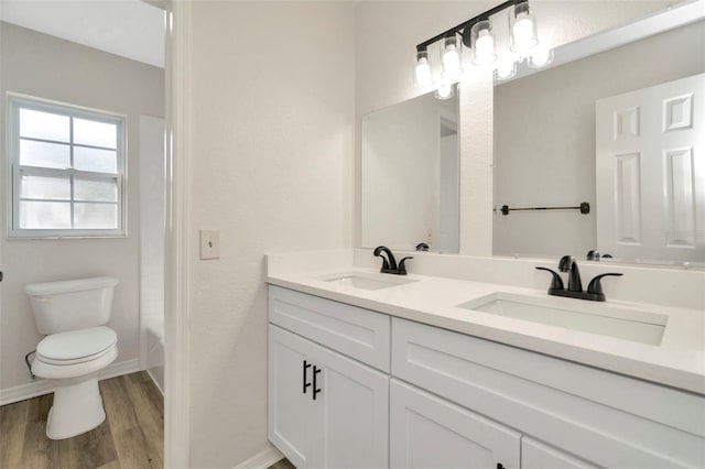 bathroom with vanity, hardwood / wood-style floors, and toilet