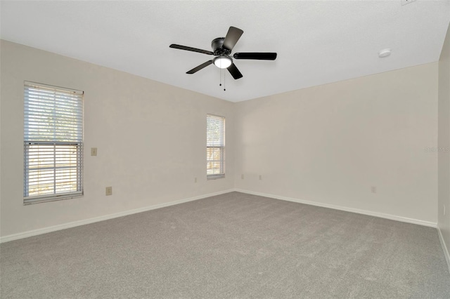 empty room with light colored carpet and ceiling fan