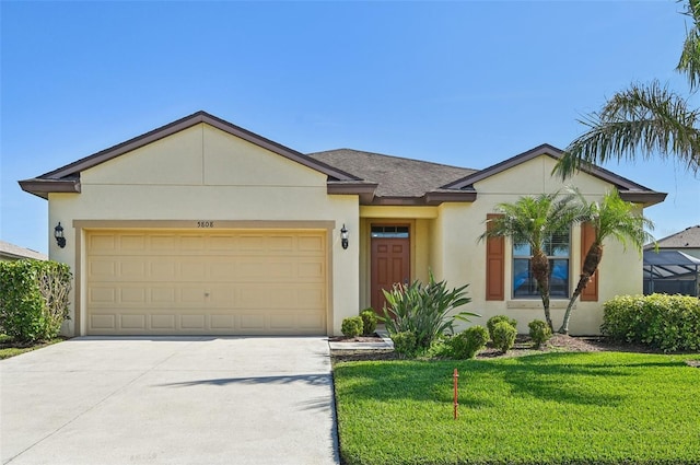 view of front of house featuring a garage and a front lawn