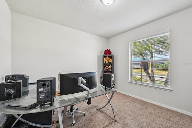 home office featuring carpet floors and a textured ceiling