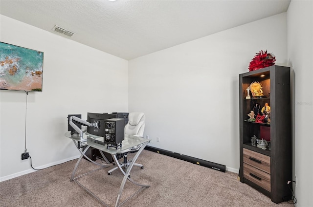 carpeted office with a textured ceiling