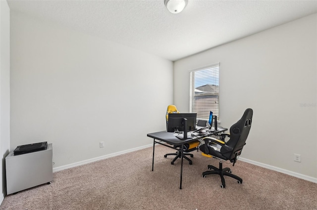 office featuring light carpet and a textured ceiling