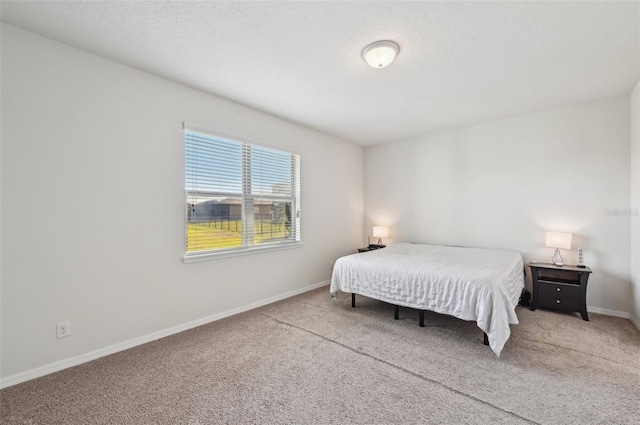 bedroom with carpet and a textured ceiling