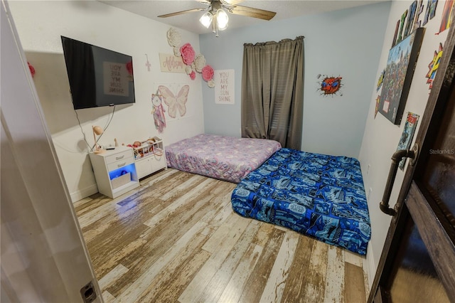 bedroom featuring hardwood / wood-style floors and ceiling fan