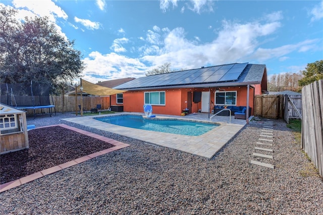 view of swimming pool with a trampoline, an outdoor hangout area, and a patio area