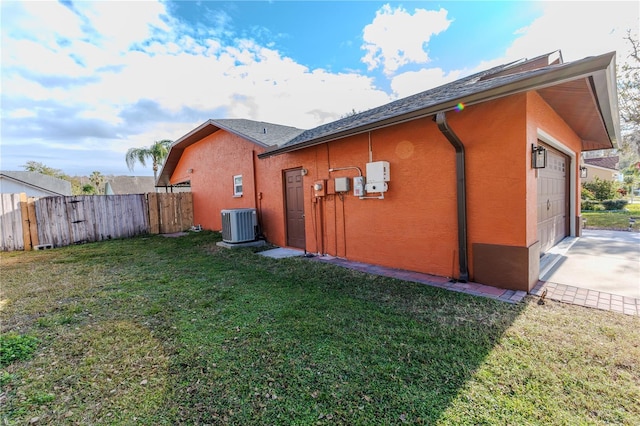 exterior space featuring central AC and a lawn