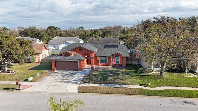 view of front of home with a garage and a front lawn