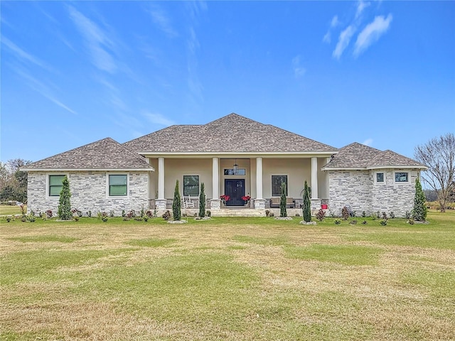 back of property with covered porch and a yard