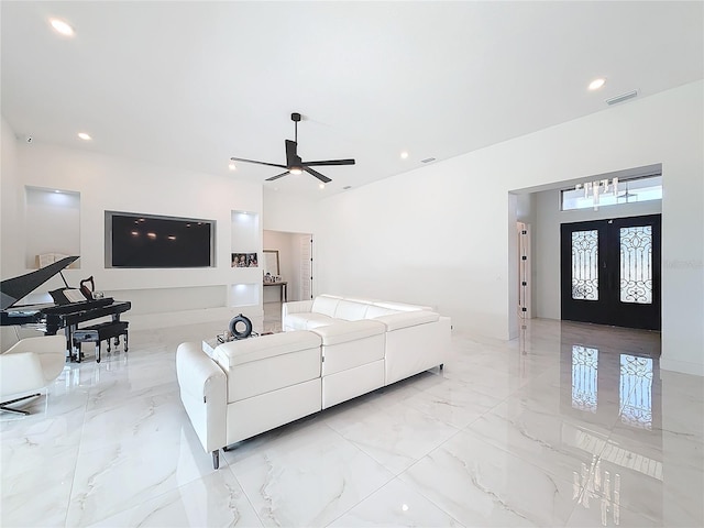 living room with ceiling fan and french doors