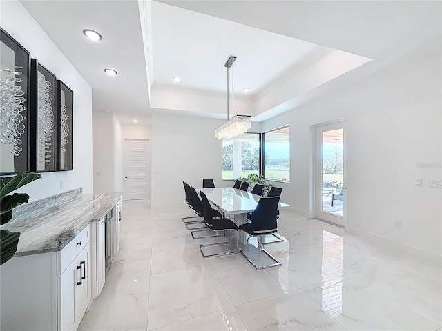 dining space featuring a tray ceiling