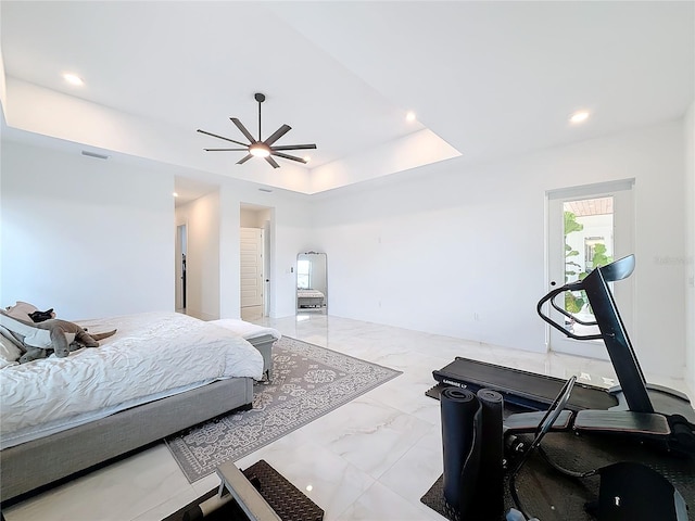 bedroom featuring ceiling fan and a tray ceiling