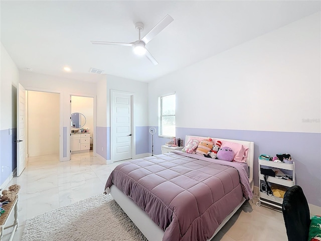 bedroom featuring ceiling fan and ensuite bath